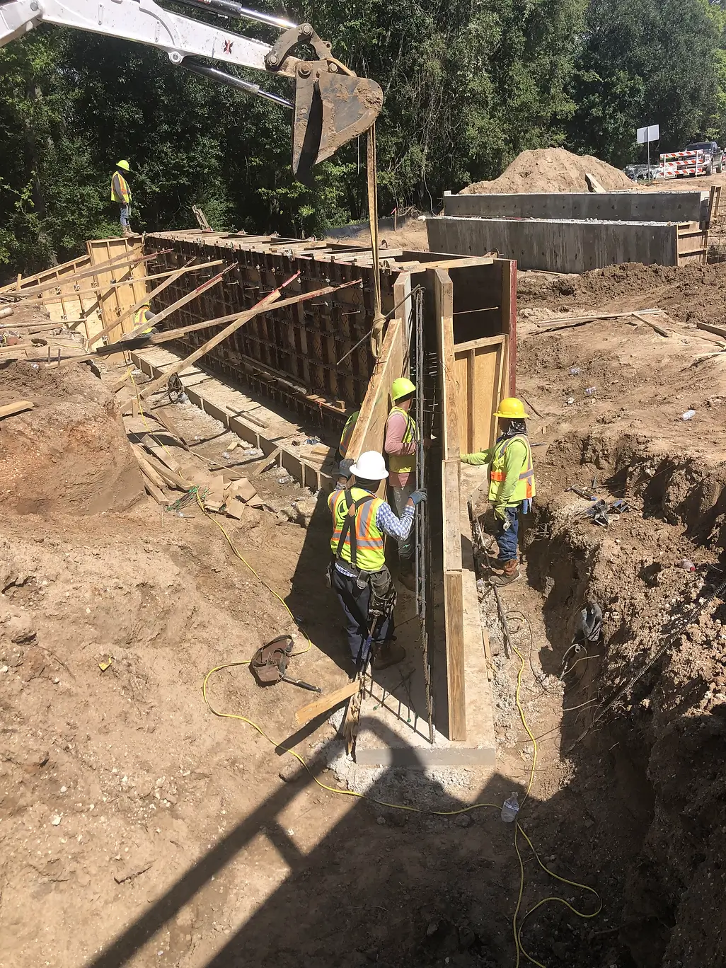 a field crew installing steel components with a bulldozer